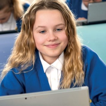 A primary school girl using a laptop