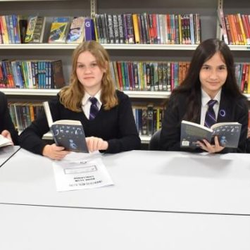 A group of secondary school girls sitting in a library