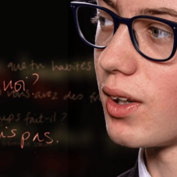 A schoolboy next to some French text