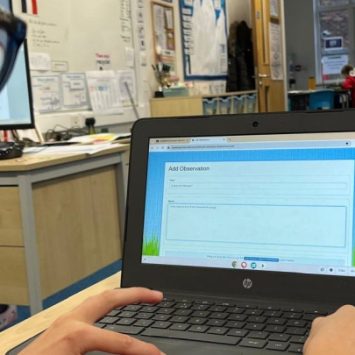A primary school boy using Tapestry on a laptop in a classroom