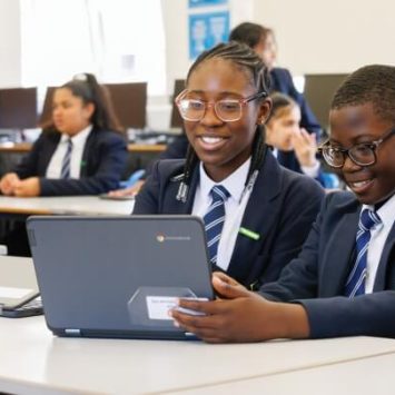 Two secondary school students working on a laptop