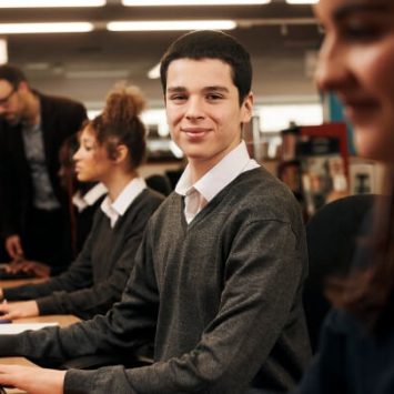 A secondary school boy working at a computer
