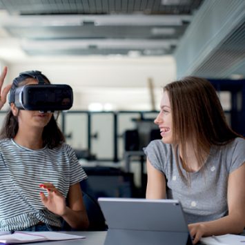 Two secondary school girls using a VR headset