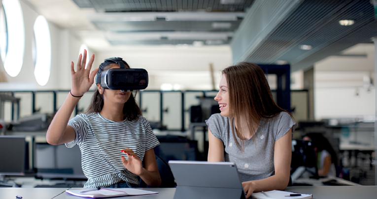 Two secondary school girls using a VR headset