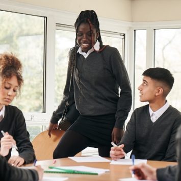 A group of secondary school students around a desk