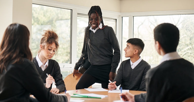 A group of secondary school students around a desk
