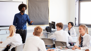Teacher teaching teenagers, representing curriculum and assessment review