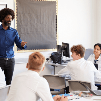Teacher teaching teenagers, representing curriculum and assessment review