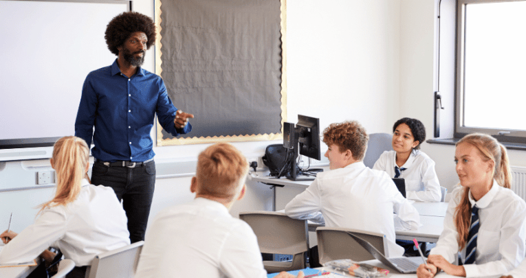 Teacher teaching teenagers, representing curriculum and assessment review