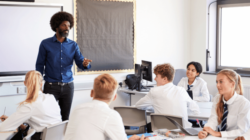 Teacher teaching teenagers, representing curriculum and assessment review