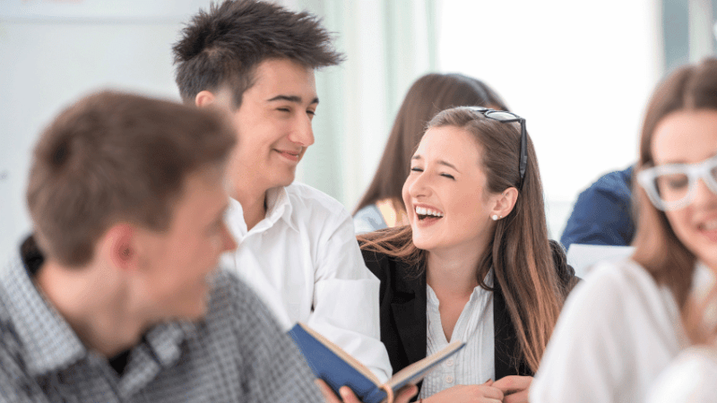 Teenager students playing Spanish games in class