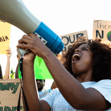 Student taking part in climate protest, representing teaching citizenship