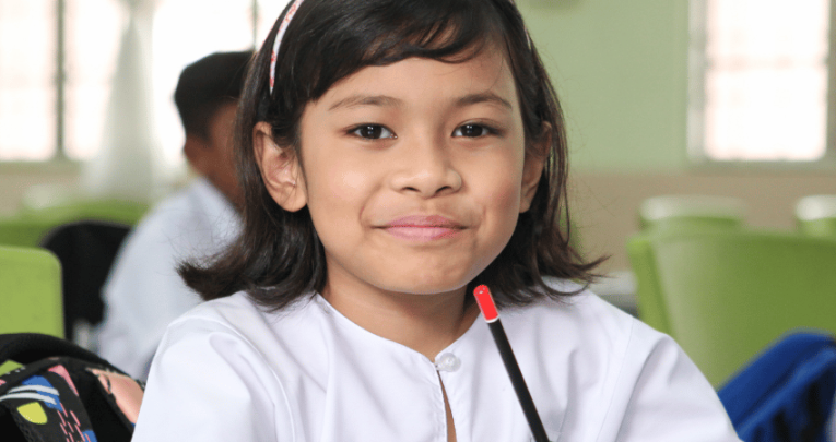 Young girl in classroom, representing school readiness