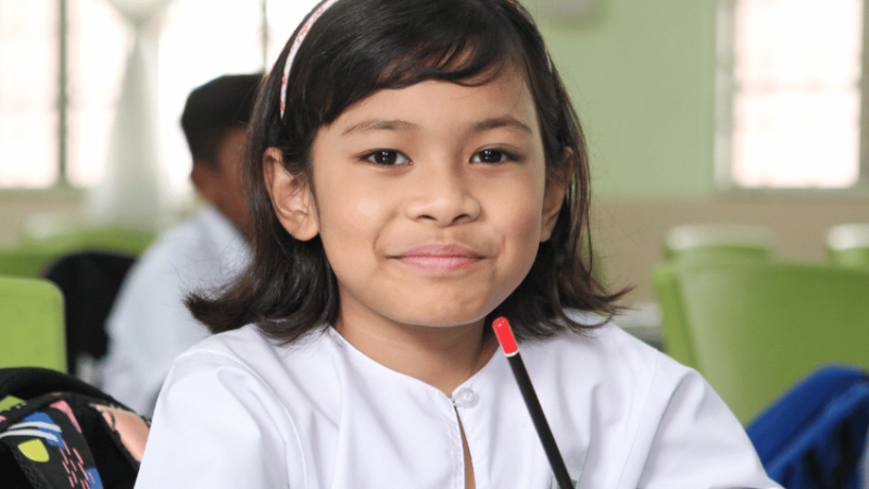 Young girl in classroom, representing school readiness