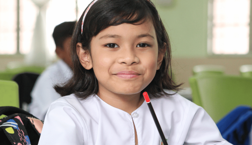 Young girl in classroom, representing school readiness