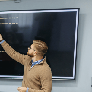 Teacher teaching coding, representing teacher shortage subjects