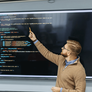 Teacher teaching coding, representing teacher shortage subjects