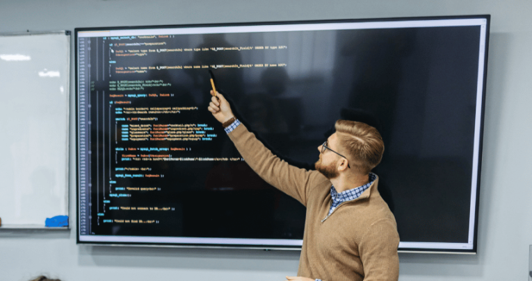 Teacher teaching coding, representing teacher shortage subjects