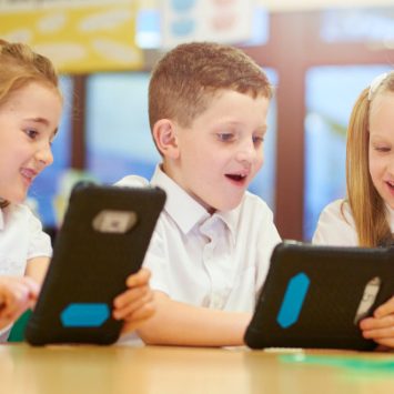 A group of primary school children using tablets