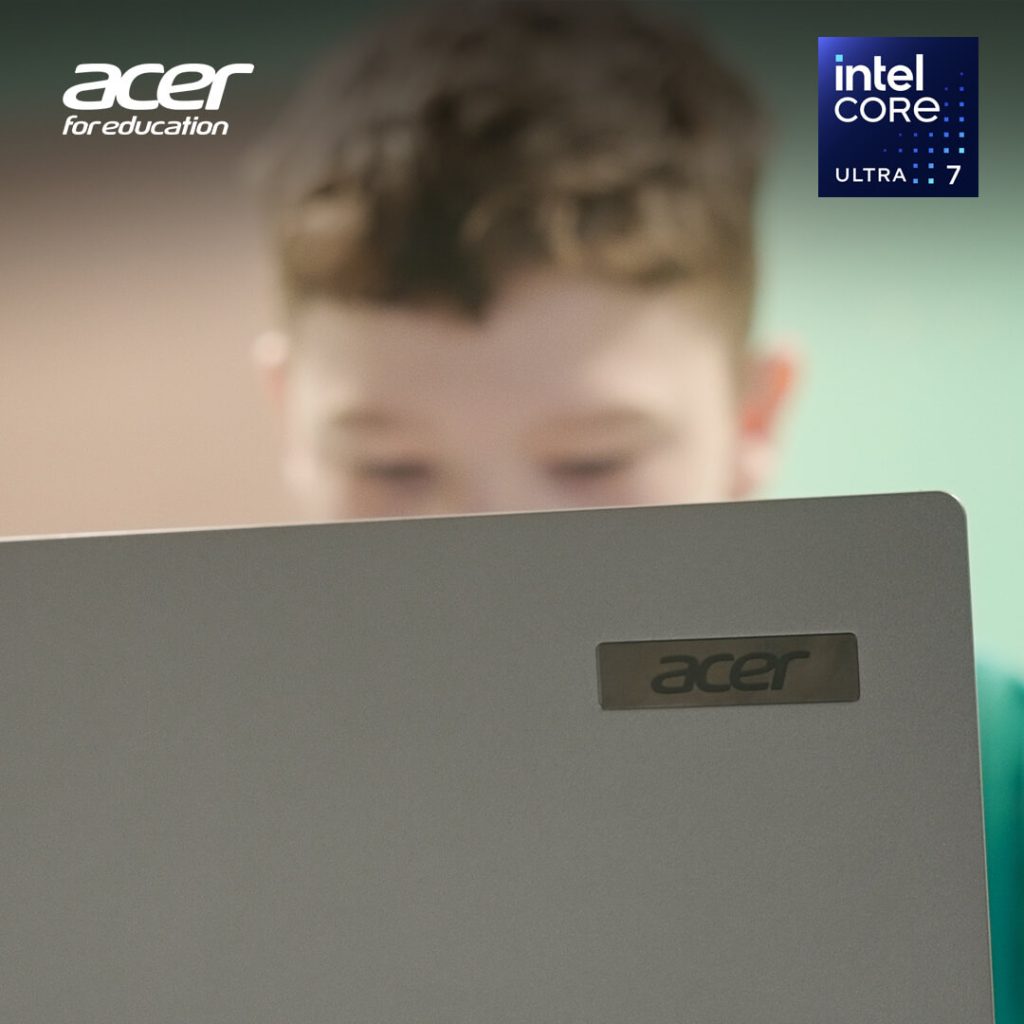 A school boy working on a laptop