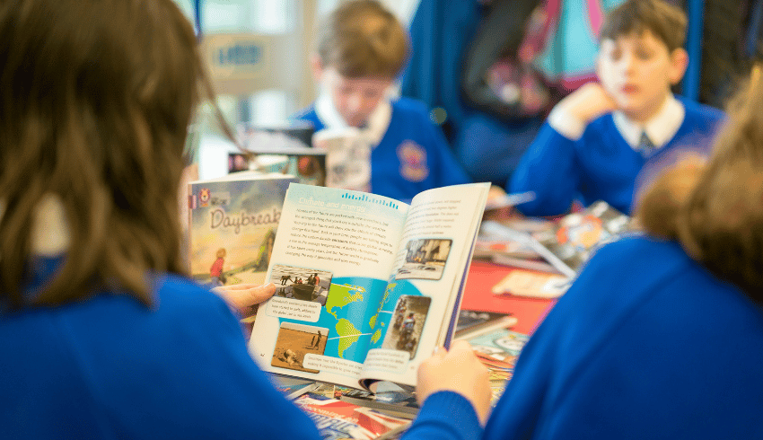 Primary children reading Collins Big Cat books