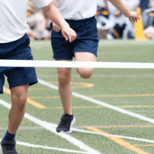 Children running towards finish line at sports day