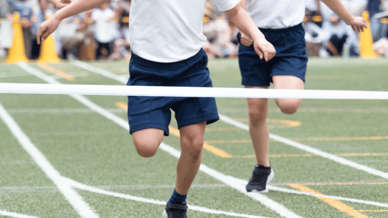Children running towards finish line at sports day