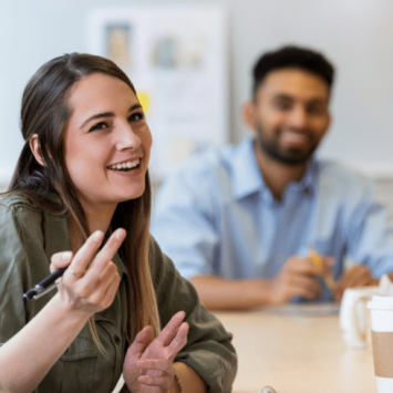 Smiling colleagues in meeting, representing staff morale