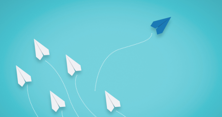 Blue paper aeroplane going a different direction to white ones, representing different teaching styles