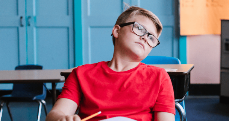 Bored boy at school, representing Year 7 school engagement decline