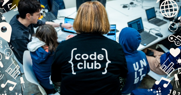 A teacher overseeing pupils using Code Club resources