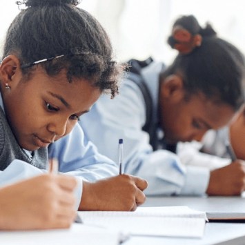 School pupils writing, representing dyslexia and processing information