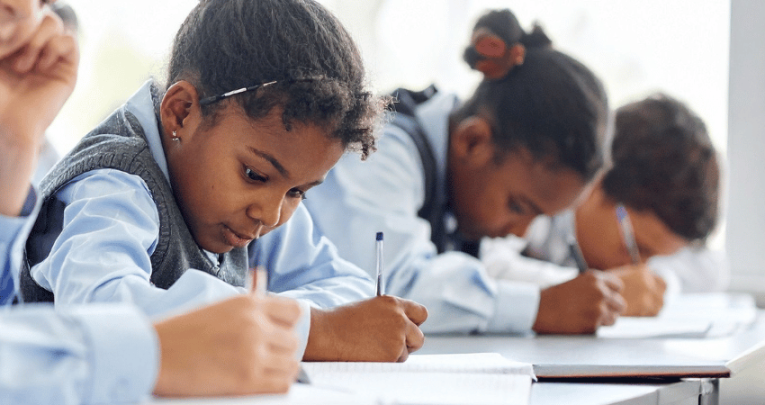 School pupils writing, representing dyslexia and processing information