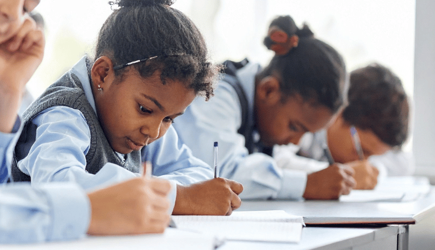 School pupils writing, representing dyslexia and processing information