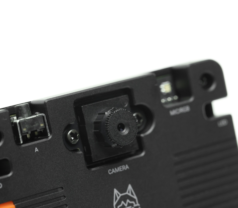 A close-up shot of the HUSKYLENS 2 AI camera's camera