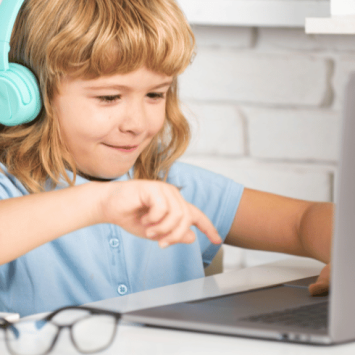 Child using laptop to take part in primary alternative provision