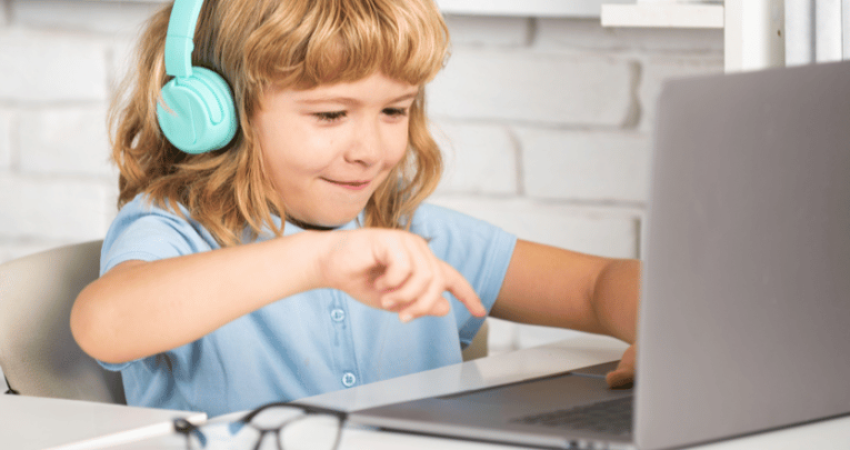 Child using laptop to take part in primary alternative provision
