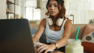 Teenager using revision tools on laptop