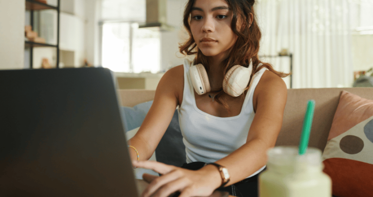 Teenager using revision tools on laptop