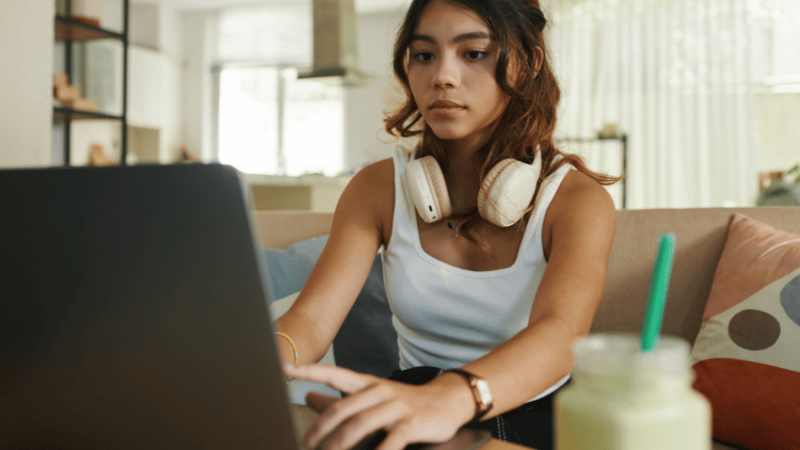 Teenager using revision tools on laptop
