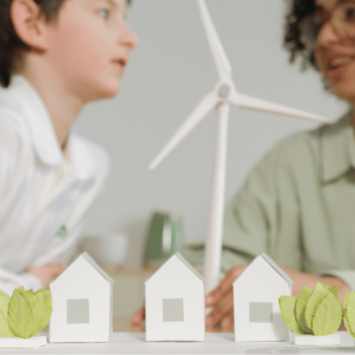 Teacher and pupil, with model of wind turbine, representing schools and sustainability