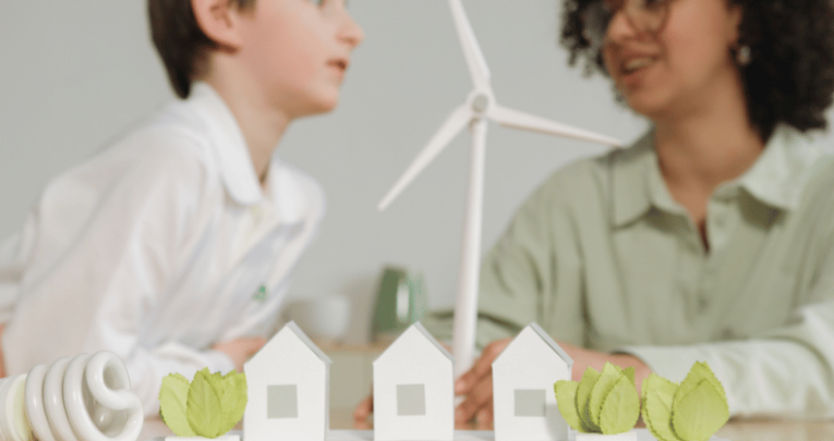 Teacher and pupil, with model of wind turbine, representing schools and sustainability