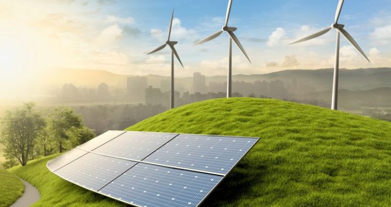 A solar panel on a hill; wind turbines below