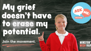 A school girl standing in front of a blackboard