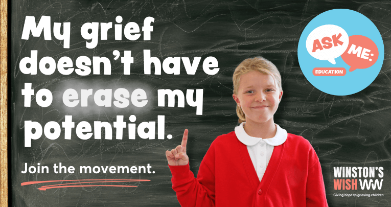 A school girl standing in front of a blackboard
