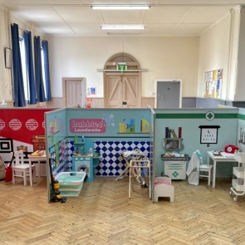 Little City role-play areas set up in a school hall