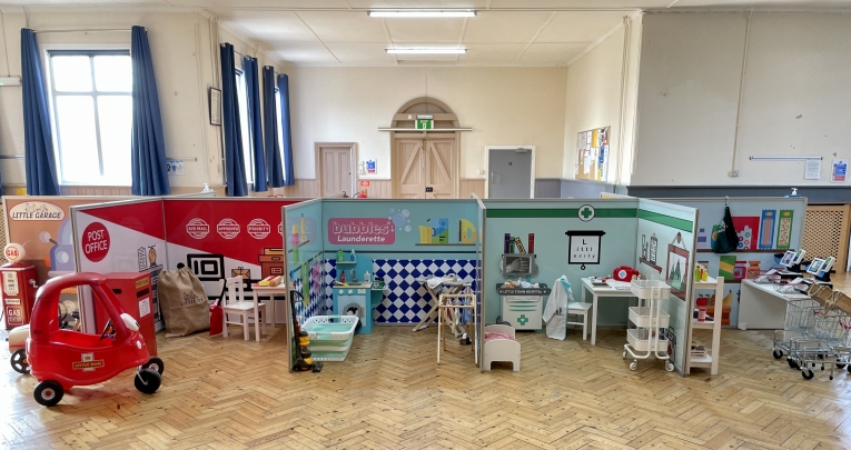 Little City role-play areas set up in a school hall