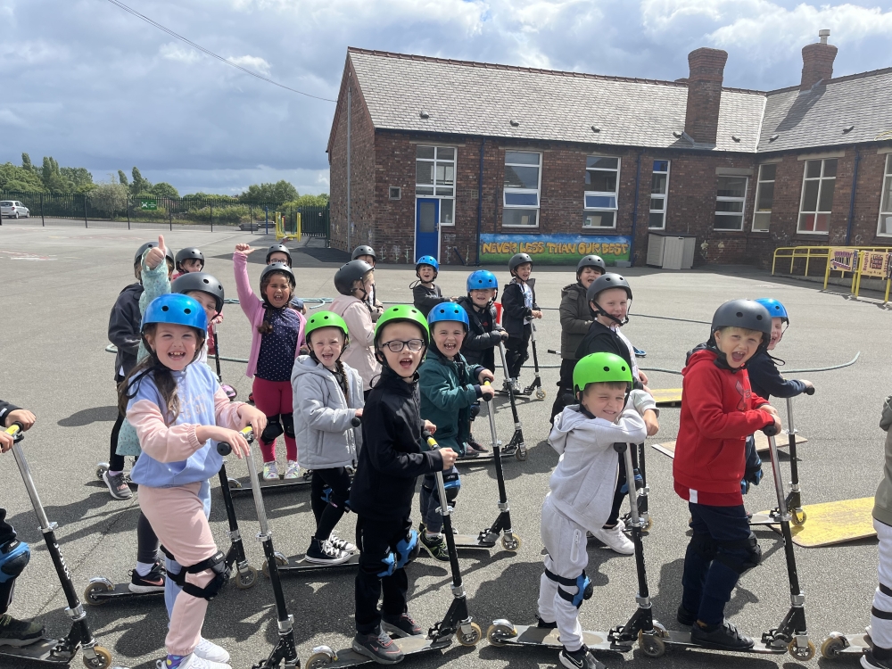 A group of primary schoolchildren on scooters in a school playground