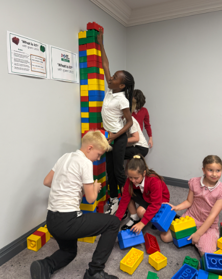 School children playing with LEGO