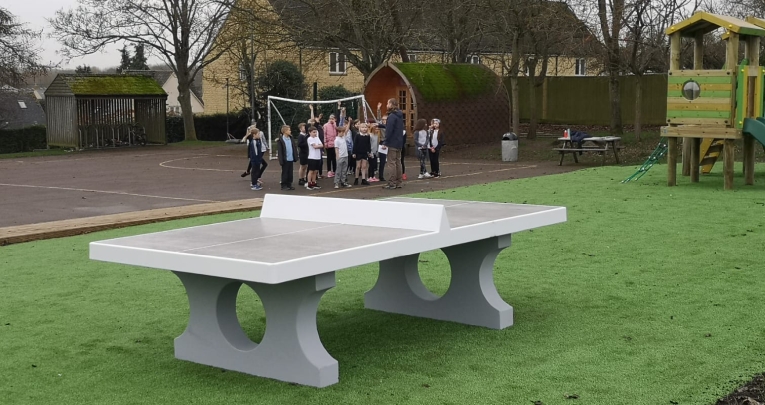 A playcrete table tennis table in a school field